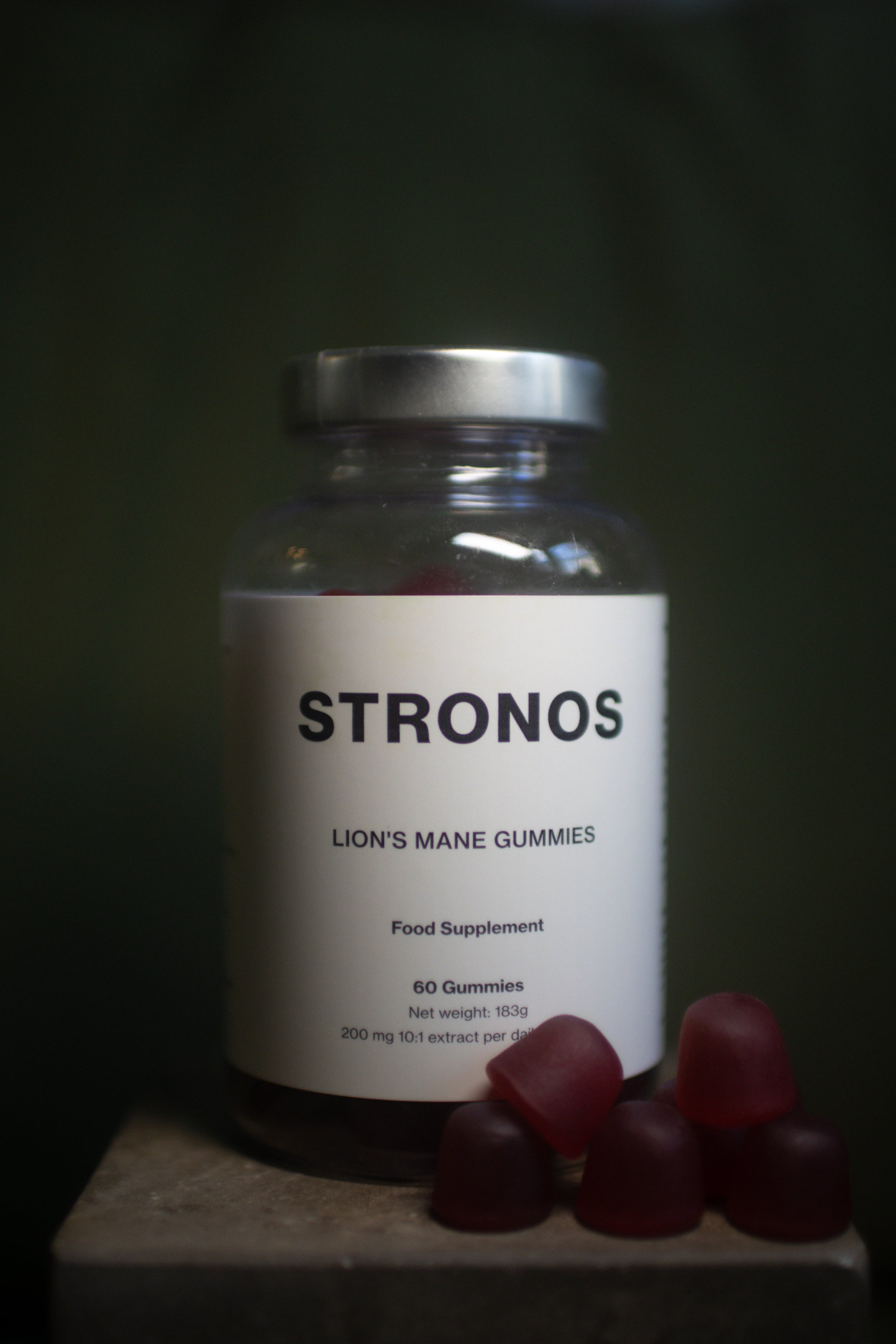 Jar of STRONOS Lions Mane Gummies on a dark background